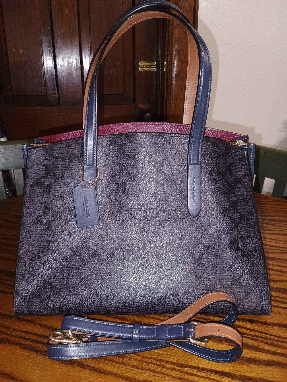 Coach Navy Signature Tote with A Wine Color Interior .